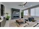 Comfortable living room features modern fireplace, ceiling fan, sleek decor, and natural light at 7999 Pinnacle Peak Ave, Las Vegas, NV 89113