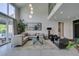 Well-lit living room with high ceilings, neutral decor, and access to the backyard at 7999 Pinnacle Peak Ave, Las Vegas, NV 89113