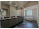 Modern main bathroom features a double vanity, sleek fixtures, and a standalone soaking tub at 7999 Pinnacle Peak Ave, Las Vegas, NV 89113