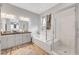 Bright bathroom showcasing a soaking tub, glass-enclosed shower, and modern vanity with double sinks at 8144 Skye Dragon St, Las Vegas, NV 89166