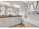 Modern bathroom with a luxurious soaking tub, double sink vanity, and contemporary fixtures at 8144 Skye Dragon St, Las Vegas, NV 89166