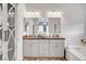 Stylish bathroom featuring a double sink vanity, soaking tub, and elegant fixtures and finishes at 8144 Skye Dragon St, Las Vegas, NV 89166