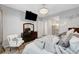 Bedroom with a mounted TV, ceiling fan and decorative curtains at 8144 Skye Dragon St, Las Vegas, NV 89166