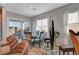 Cozy dining area with elegant chairs and a modern table, complemented by an harp and lots of light at 8144 Skye Dragon St, Las Vegas, NV 89166