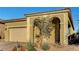 Inviting home showcasing an arched entryway and lush landscaping at 8144 Skye Dragon St, Las Vegas, NV 89166