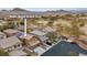 An aerial view of homes near a lush golf course with mountain views in the scenic Las Vegas valley at 8683 Bella Jewel Ave, Las Vegas, NV 89178