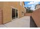 An outdoor patio features neutral tones, with a view of the staircase visible through the sliding glass door at 8683 Bella Jewel Ave, Las Vegas, NV 89178