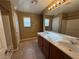 Bathroom with dual sinks, tiled floors, and well lit mirror at 8683 Bella Jewel Ave, Las Vegas, NV 89178