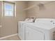 Laundry room featuring a washer, a dryer, and shelving at 8683 Bella Jewel Ave, Las Vegas, NV 89178