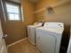 A small, dedicated laundry room area with a washing machine and dryer at 8683 Bella Jewel Ave, Las Vegas, NV 89178