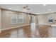 Neutral-toned living room with wood-style flooring and natural light at 8683 Bella Jewel Ave, Las Vegas, NV 89178