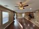 Bright living room with hardwood floors, a ceiling fan, and an open view to the kitchen at 8683 Bella Jewel Ave, Las Vegas, NV 89178