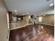 Spacious living room featuring hardwood floors seamlessly flowing into the kitchen area at 8683 Bella Jewel Ave, Las Vegas, NV 89178