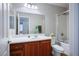 Bright bathroom featuring a wooden vanity with a white countertop and a shower with glass doors at 9489 Liquid Loco St, Las Vegas, NV 89178