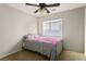 Bright bedroom with a ceiling fan, carpeted floor, and a window bringing in natural light at 9489 Liquid Loco St, Las Vegas, NV 89178