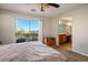 Bright bedroom with a sliding glass door to a balcony and ensuite bath with wood vanity at 9489 Liquid Loco St, Las Vegas, NV 89178