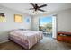 Bedroom featuring a sliding door leading to a balcony with views, ceiling fan, and carpeted floors at 9489 Liquid Loco St, Las Vegas, NV 89178