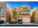 Charming two-story home featuring a balcony, manicured lawn, and two car garage at 9489 Liquid Loco St, Las Vegas, NV 89178