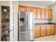 Spacious kitchen with stainless steel fridge, ample cabinet space, and pantry at 9489 Liquid Loco St, Las Vegas, NV 89178