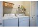 Convenient laundry room with a washer, dryer, and shelving for storage and organizing supplies at 9489 Liquid Loco St, Las Vegas, NV 89178