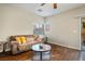 Cozy living room featuring wood floors, neutral walls, and a sliding glass door at 9489 Liquid Loco St, Las Vegas, NV 89178