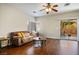 Cozy living room featuring wood floors, neutral walls, and a sliding glass door at 9489 Liquid Loco St, Las Vegas, NV 89178