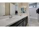 This bathroom boasts a double sink, a soaking tub, and modern fixtures that add a touch of elegance at 9519 Chandler Springs Ave, Las Vegas, NV 89148