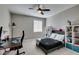 This bedroom has a modern ceiling fan, a window letting in natural light, and updated decor at 9519 Chandler Springs Ave, Las Vegas, NV 89148