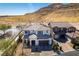 Inviting two-story home with a neutral color scheme, desert landscaping, and mountain views at 9519 Chandler Springs Ave, Las Vegas, NV 89148