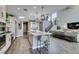 Open-concept kitchen featuring a large island with pendant lighting and modern appliances at 9519 Chandler Springs Ave, Las Vegas, NV 89148