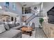 Spacious living room featuring a sectional sofa, wooden floors, and a view of the adjacent kitchen at 9519 Chandler Springs Ave, Las Vegas, NV 89148