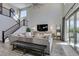 Living room with staircase, large TV, and sliding door access to outdoor living space at 9519 Chandler Springs Ave, Las Vegas, NV 89148