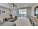 Spacious upstairs living room area with a large sectional sofa, entertainment center, and modern ceiling fan at 9519 Chandler Springs Ave, Las Vegas, NV 89148