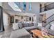 Bright living room with a large sectional and views into the kitchen, featuring an open floor plan at 9519 Chandler Springs Ave, Las Vegas, NV 89148