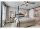 Comfortable main bedroom featuring a four-poster bed, ceiling fan, and access to the ensuite bathroom at 9519 Chandler Springs Ave, Las Vegas, NV 89148