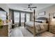 Comfortable main bedroom featuring a four-poster bed, ceiling fan, and lots of natural light at 9519 Chandler Springs Ave, Las Vegas, NV 89148