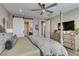 Comfortable main bedroom featuring a four-poster bed, ceiling fan, and ensuite bathroom access at 9519 Chandler Springs Ave, Las Vegas, NV 89148