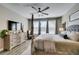 Comfortable main bedroom featuring a four-poster bed, ceiling fan, and bright, natural light at 9519 Chandler Springs Ave, Las Vegas, NV 89148