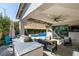 An outdoor kitchen provides a perfect space for entertaining, complete with a grill, countertops, and seating at 9519 Chandler Springs Ave, Las Vegas, NV 89148