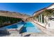 Beautiful backyard pool with a jacuzzi, sleek stonework, and lush privacy landscaping creating a backyard oasis at 9519 Chandler Springs Ave, Las Vegas, NV 89148