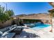 The pool area is a luxurious oasis featuring a modern pool, a jacuzzi, and an outdoor seating arrangement at 9519 Chandler Springs Ave, Las Vegas, NV 89148