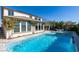 Stunning backyard oasis with a sparkling blue pool, spa, and an outdoor kitchen at 9519 Chandler Springs Ave, Las Vegas, NV 89148