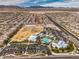 An aerial view shows a community center with a pool, large parking area, and open recreation space at 9655 Shadow Cliff Ave, Las Vegas, NV 89166