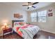 Bright bedroom featuring stylish floral bedding, natural light, and wood-look flooring at 9655 Shadow Cliff Ave, Las Vegas, NV 89166