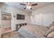 Comfortable bedroom has a ceiling fan, carpet, a TV, and ample space at 9655 Shadow Cliff Ave, Las Vegas, NV 89166