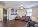 Bonus room with ceiling fan, dark wood floors, and comfortable seating at 9655 Shadow Cliff Ave, Las Vegas, NV 89166