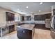 Modern kitchen features stainless steel appliances, dark cabinetry, and granite countertops at 9655 Shadow Cliff Ave, Las Vegas, NV 89166