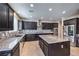 Modern kitchen featuring stainless steel appliances, dark cabinetry, and granite countertops at 9655 Shadow Cliff Ave, Las Vegas, NV 89166