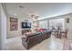 Bright living room featuring a large leather sectional, tiled floors, and a ceiling fan at 9655 Shadow Cliff Ave, Las Vegas, NV 89166