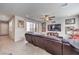 Spacious living room with tiled floors, ceiling fan, and a sliding glass door to the outside at 9655 Shadow Cliff Ave, Las Vegas, NV 89166